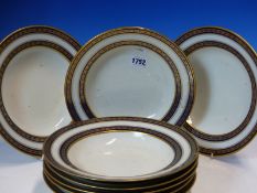 EIGHT VIENNA SOUP PLATES, EACH DECORATED WITH A RUNNING BAND OF PAIRS OF LEAVES GILT ON BLUE RIMS.