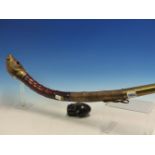 TWO BAMBOO OPIUM PIPES WITH LEATHER AND GOURD POUCHES, ONE CURVED AND BRASS MOUNTED. W 62cms. THE