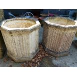A PAIR OF OCTAGONAL COMPOSITE STONE TERRACE PLANTERS WITH FLUTED SIDES, H 52cms.