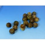 SIXTEEN CHINESE BLACK TINGED GREY HARDSTONE BEADS, THE BROCADE BALL SHAPES CARVED WITH SHOU