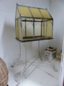 A CLOCHE ON WIRE WORK STAND AND A WICKER DOLLS PRAM.