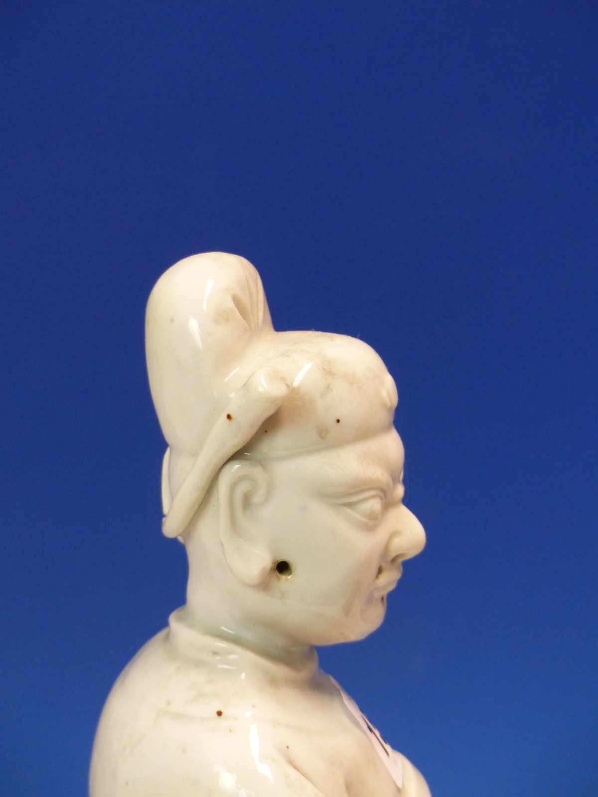 A BLANC DE CHINE FIGURE OF A FIERCE EYED MANDARIN STANDING ON A DOUBLE CLOUD PLINTH, HIS CHIN - Image 8 of 48