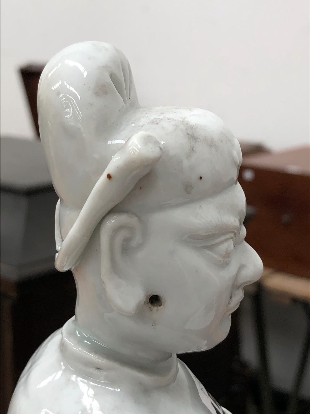 A BLANC DE CHINE FIGURE OF A FIERCE EYED MANDARIN STANDING ON A DOUBLE CLOUD PLINTH, HIS CHIN - Image 34 of 48