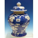 A CHINESE BLUE AND WHITE BALUSTER JAR AND COVER PAINTED WITH WHITE CHERRY BLOSSOMS AGAINST A BLUE