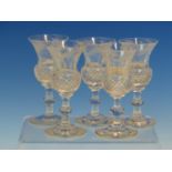 A SET OF FIVE THISTLE SHAPED WHISKY GLASSES WITH THE SIXTH FORMING THE STOPPER TO AN INVERTED