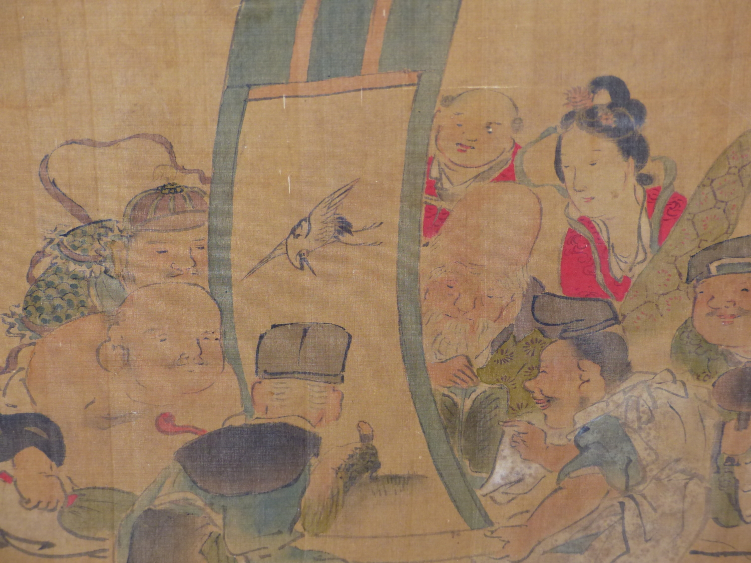 A JAPANESE WATERCOLOUR OF THE SEVEN GODS OF GOOD FORTUNE ADMIRING A SCROLL PAINTING TOGETHER WITH