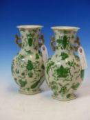 A PAIR OF CHINESE LOBED FORM TWIN HANDLED VASES. GREEN DECORATION OF VARIOUS SYMBOLS. H. 23cms (