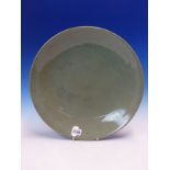 A CHINESE CRACKLED CELADON DISH. Dia. 37cms.