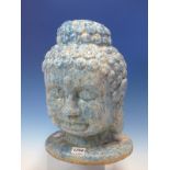 A TURQUOISE MARBLED TERRACOTTA HEAD OF THE BUDDHA MODELLED WITH THIRD EYE AND CURLED HAIR. H 34cms.