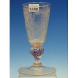 AN 18th C. GERMAN ALE GLASS, THE BOWL CUT AND ENGRAVED WITH FLOWERS ABOVE A RED TWIST BALUSTER