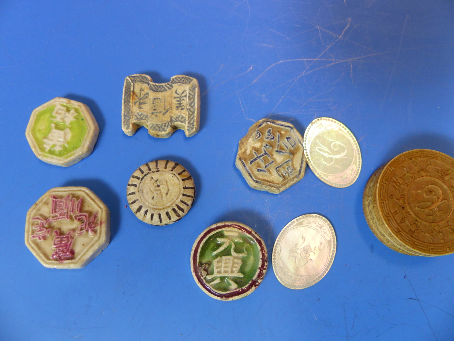 SIX CHINESE PORCELAIN GAMBLING TOKENS TOGETHER WITH MOTHER OF PEARL COUNTERS INITIALLED C, SOME