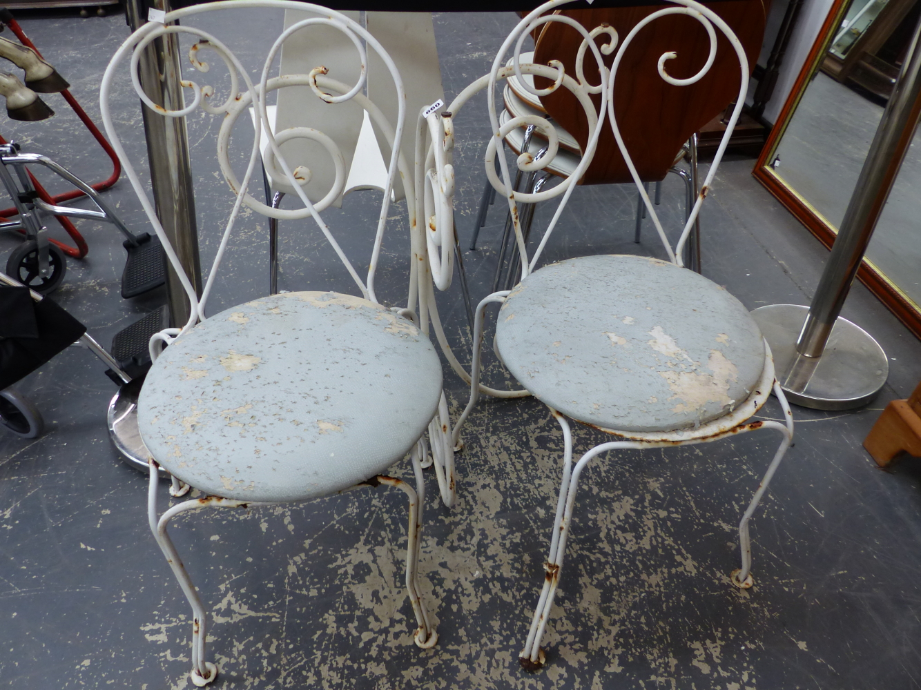 A PAIR OF WROUGHT IRON PATIO CHAIRS, TOGETHER WITH A CONSOLE TABLE BASE.