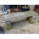 A PEDESTAL GARDEN BENCH.