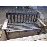 A TEAK GARDEN BENCH TOGETHER WITH A SIMILAR TABLE.