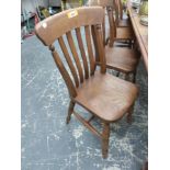 A HARLEQUIN SET OF EIGHT ANTIQUE SLAT BACK KITCHEN CHAIRS.