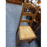 A SET OF SIX MODERN OAK DINING CHAIRS WITH RUSH SEATS.