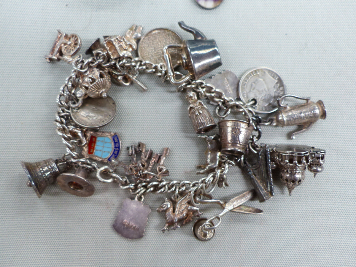 A SILVER CHARM BRACELET, A SILVER SCOTTISH THISTLE BROOCH, AND A BLUE JOHN SILVER CASED PENDANT. - Image 4 of 4