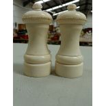 A PAIR OF IVORY PEPPER MILLS, HEIGHT 11cms.