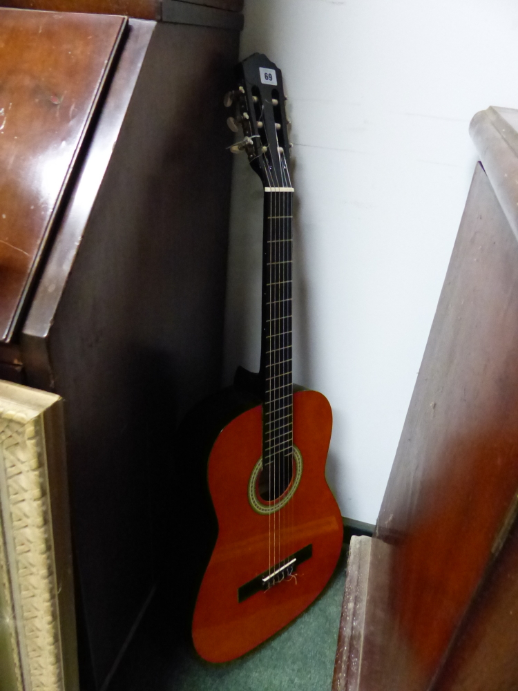 AN ACOUSTIC GUITAR.