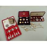 A SET OF SIX HALLMARKED SILVER CASED TEA SPOONS, A FURTHER SET OF SIX WHITE METAL TEA SPOONS, A