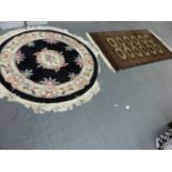 A CHINESE CIRCULAR RUG AND ONE OTHER.