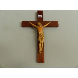 A 19TH C. CARVED IVORY OF CHRIST CRUCIFIED ON LATER WOODEN CROSS.