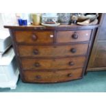 A VICTORIAN MAHOGANY BOW FRONT CHEST OF DRAWERS.