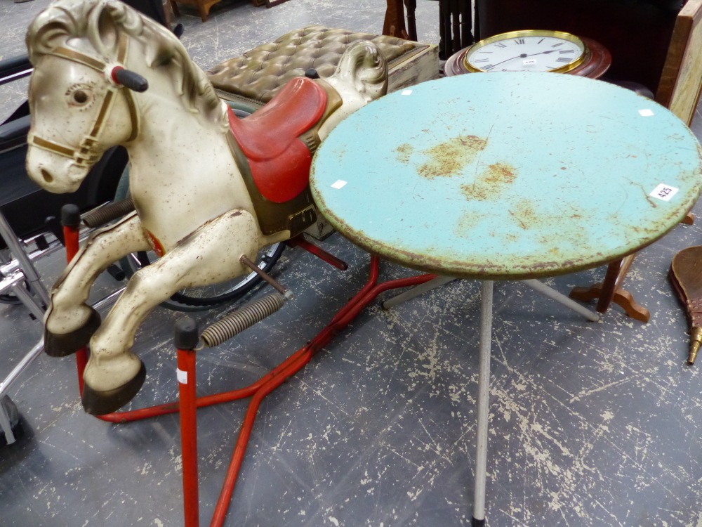 A MOBO TIN ROCKING HORSE AND A SMALL RETRO TABLE.