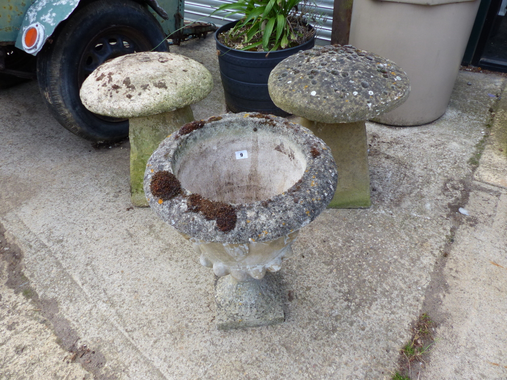 A PAIR OF STADDLE STONE AND A GARDEN URN.