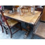 A SMALL OAK REFECTORY TABLE.