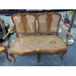 A FRENCH WALNUT SHOW FRAME SMALL SALON SETTEE, AND A SIMILAR ARM CHAIR.