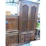 A EASTERN HARDWOOD WARDROBE AND A PAIR OF BEDSIDE CABINETS.