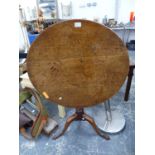 AN OAK TILT TOP TABLE.