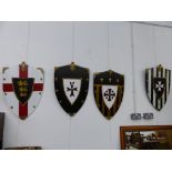 FOUR DECORATIVE WALL SHIELDS.