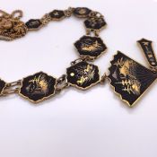 A JAPANESE GOLD AND SILVER INLAID NECKLACE, THE TWELVE HEXAGONAL BLACK METAL PLATES JOINED TO A