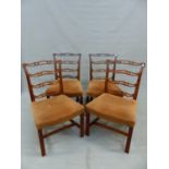 A SET OF FOUR MAHOGANY PIERCED LADDER BACKED CHAIRS, THE UPHOLSTERED SEATS OVER A CHANNELLED FRONT