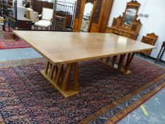 AN AFRORMOSIA WOOD DINING TABLE, THE CLEATED RECTANGULAR TOP ON TEN INTERARCHED BAR TRESTLES