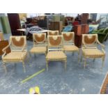 A SET OF SIX REGENCY STYLE CANE BACKED DINING CHAIRS. THE TOP RAILS GILT WITH A BAND OF ANTHEMION