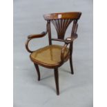 A THONET LABELLED CHILDS ELBOW CHAIR WITH A BROAD TOP RAIL OVER SEVEN STICK FAN SPLAT AND CANED