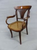 A THONET LABELLED CHILDS ELBOW CHAIR WITH A BROAD TOP RAIL OVER SEVEN STICK FAN SPLAT AND CANED