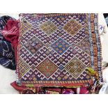 A SMALL ANTIQUE CAUCASIAN FLAT WEAVE BAG, TOGETHER WITH OTHER EASTERN TRIBAL SILK AND EMBROIDERED