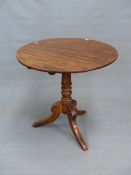 A 19th C. MAHOGANY TILT TOP TABLE, THE CIRCULAR TOP ON TURNED COLUMN