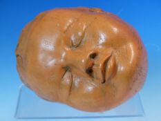 A TERRACOTTA BABYS HEAD MODELLED ASLEEP, INSCRIBED 95 BRITTA K. W 17.5cms.