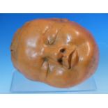 A TERRACOTTA BABYS HEAD MODELLED ASLEEP, INSCRIBED 95 BRITTA K. W 17.5cms.