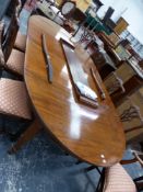 AN EDWARDIAN MAHOGANY D-END DINING TABLE CRANKING OUT TO TAKE THREE LEAVES, THE TAPERING SQUARE L