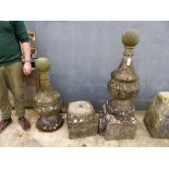 A PAIR OF LARGE CARVED STONE FINIALS WITH BALL KNOPS.