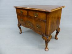 A WALNUT GEORGIAN DESIGN CHEST OF TWO SHORT DRAWERS AND A LONG DRAWER CENTRALLY RECESSED AND INLAID