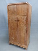 A HEAL AND SONS LTD LIMED OAK TWO DOOR SMALL WARDROBE ON BUN FEET. 84 x 50 x 179cms (H).