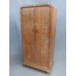 A HEAL AND SONS LTD LIMED OAK TWO DOOR SMALL WARDROBE ON BUN FEET. 84 x 50 x 179cms (H).