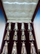 A CASED SET OF TWELVE SILVER PLATED FOX HEAD STIRRUP CUPS, EACH WITH TRUMPET SHAPED BOWL. H 14cms.